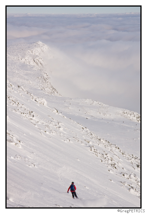 Skiing above an undercast above Huntington Ravine