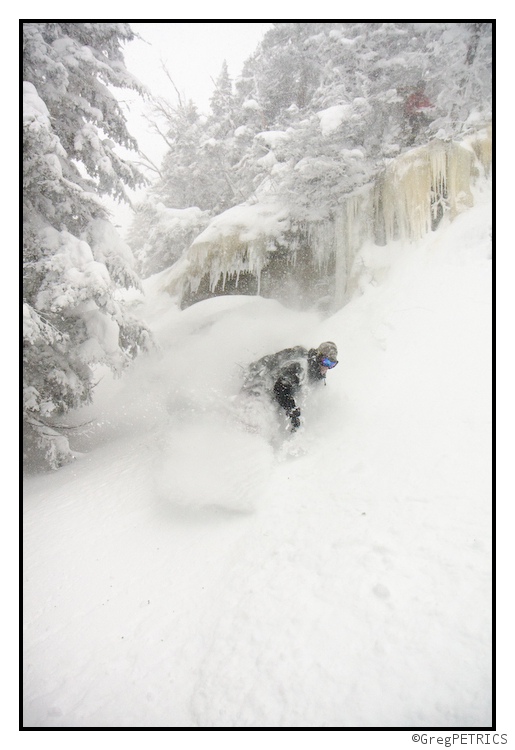 a snowboarder hucks a cliff